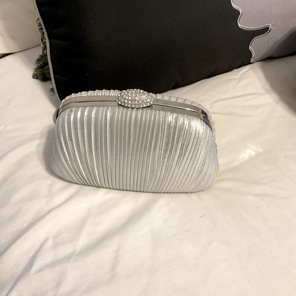 Silver clutch bag. Has a chain also
